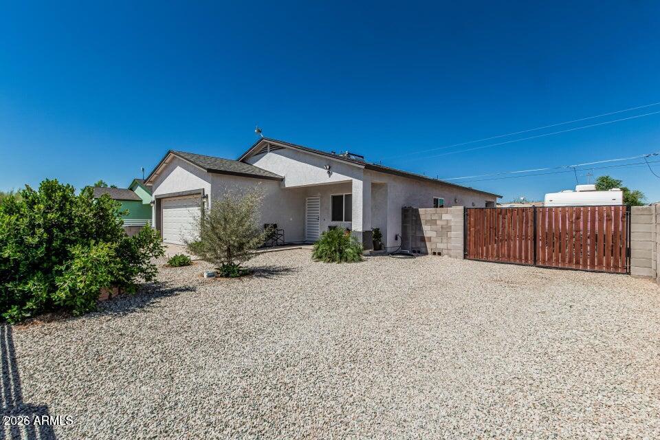 a view of a house with wooden fence
