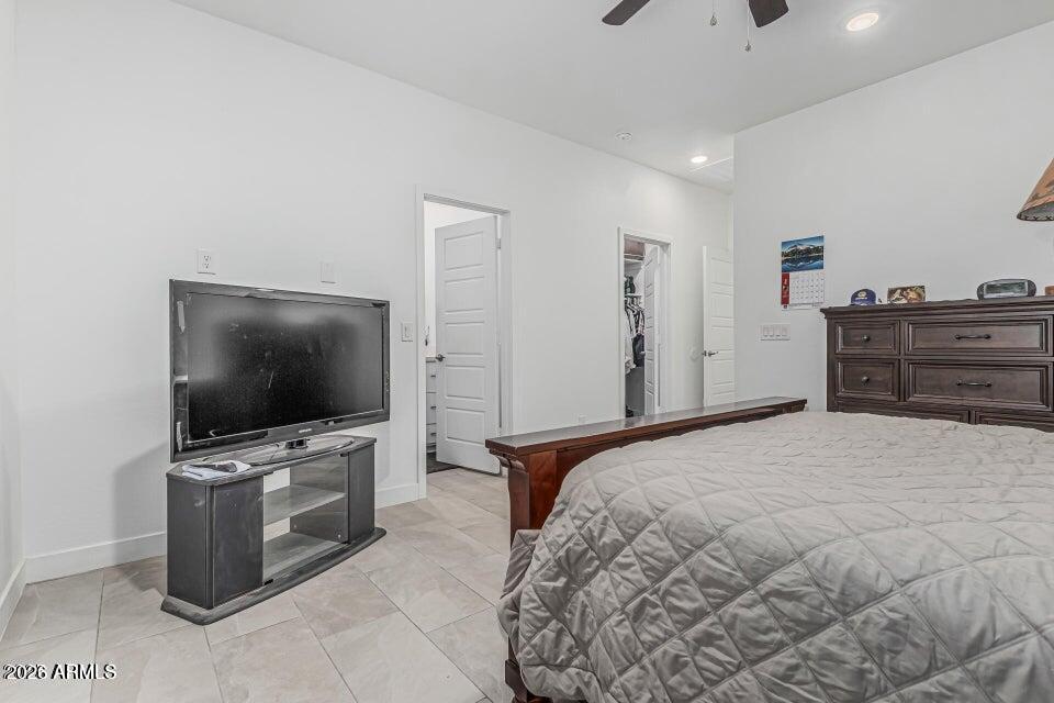 32102 North Walnut Street Wittmann, AZ 85361 - Photo 12 of 18 a bedroom with a bed and a flat screen tv