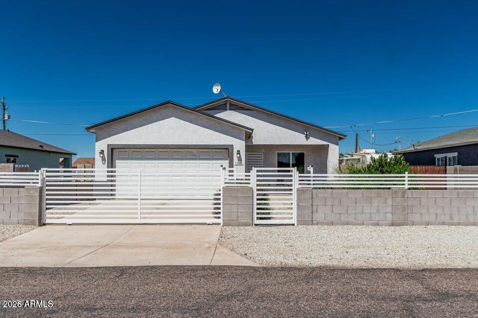 32102 North Walnut Street Wittmann, AZ 85361 - Photo 2 of 18 a front view of a house with a garage