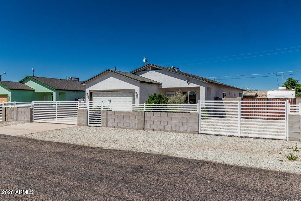 32102 North Walnut Street Wittmann, AZ 85361 - Photo 3 of 18 a front view of a house with a garage