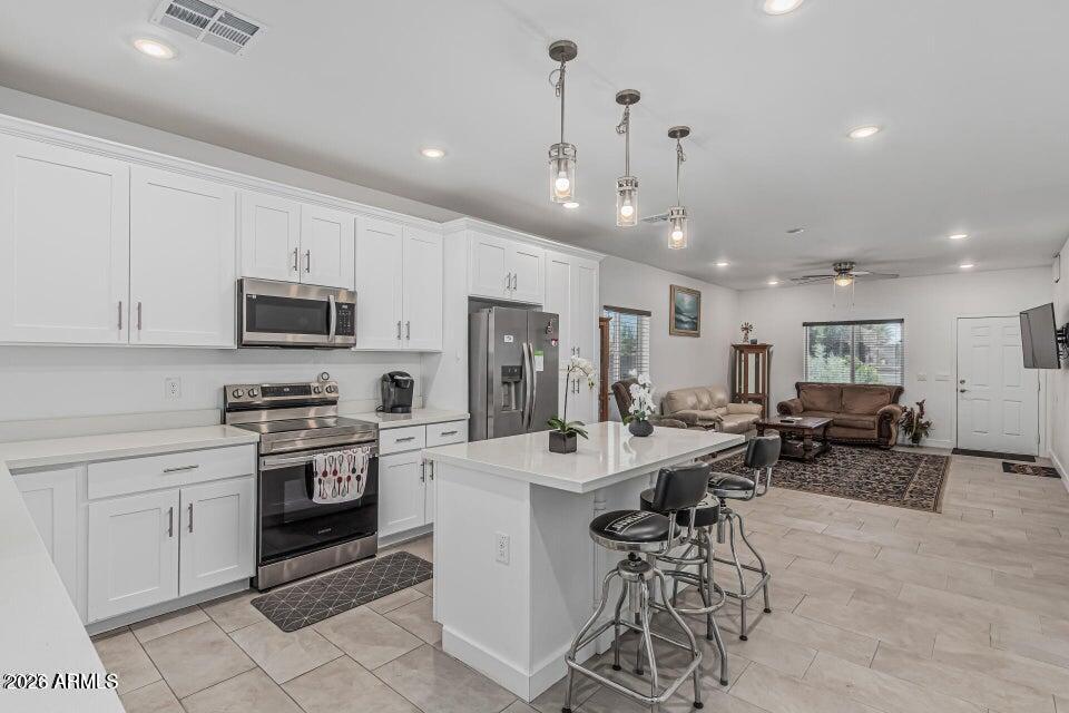 32102 North Walnut Street Wittmann, AZ 85361 - Photo 6 of 18 a large white kitchen with stainless steel appliances lots of counter space and furniture