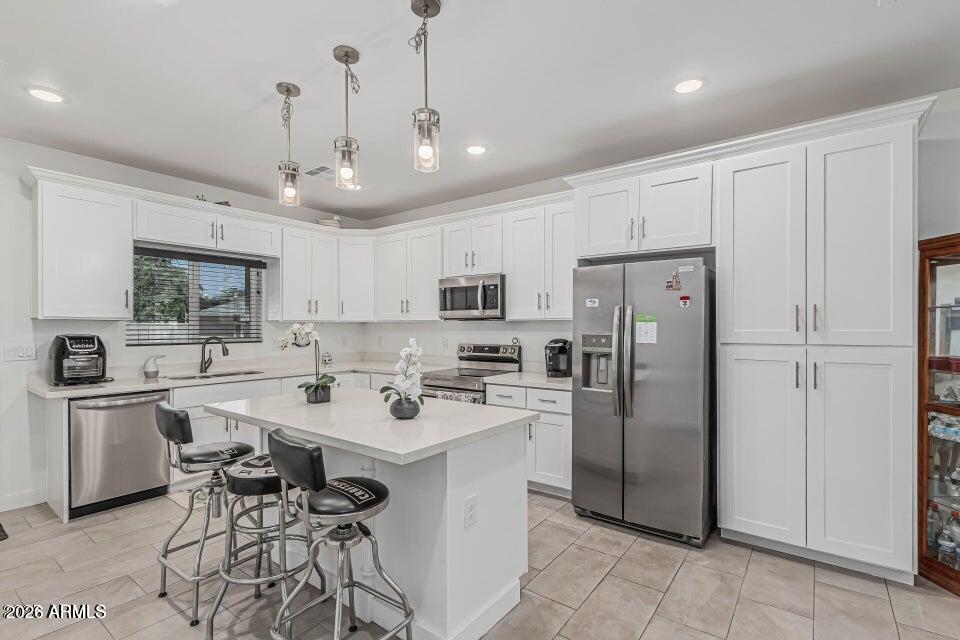 32102 North Walnut Street Wittmann, AZ 85361 - Photo 8 of 18 a kitchen with stainless steel appliances a sink a stove a refrigerator cabinets and chairs
