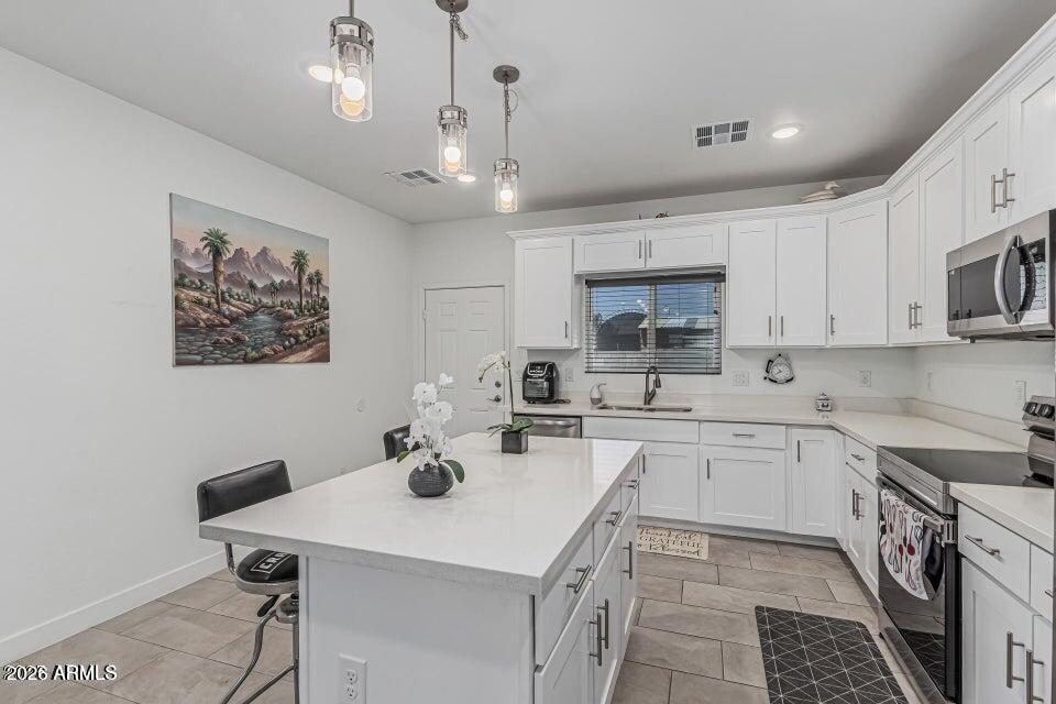32102 North Walnut Street Wittmann, AZ 85361 - Photo 9 of 18 a kitchen with a sink a stove a microwave and cabinets