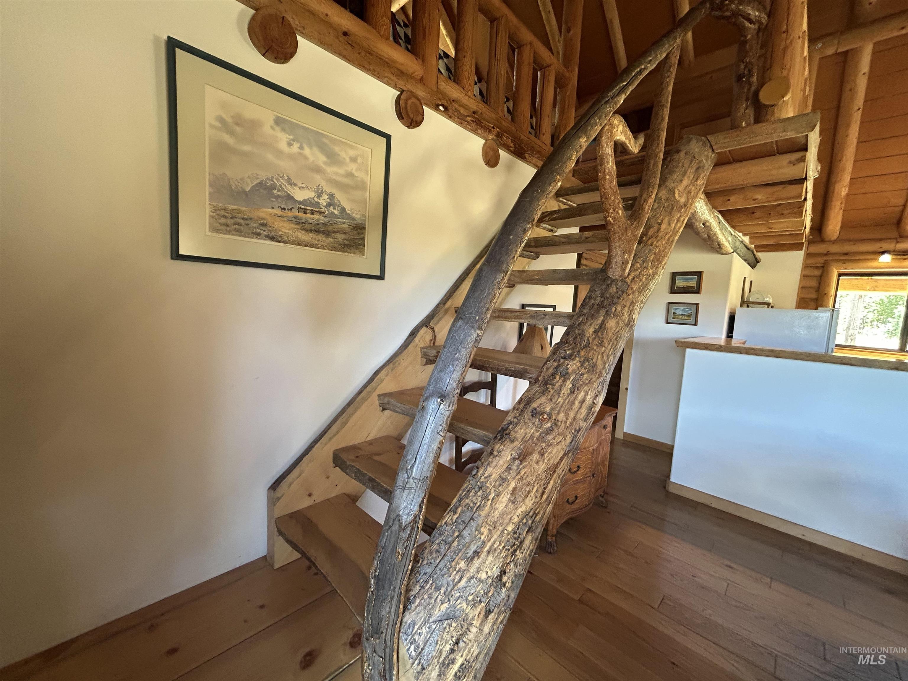 35 Sawtooth Way Stanley, ID 83278 - Photo 25 of 36 Custom natural wood staircase with log railings and wood-finish flooring