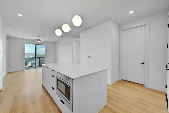 a view of a kitchen with wooden floor