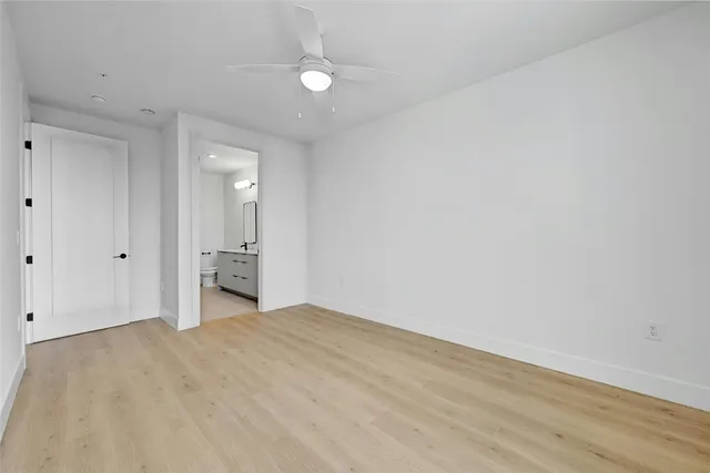 a bathroom with a double vanity sink a toilet and a mirror