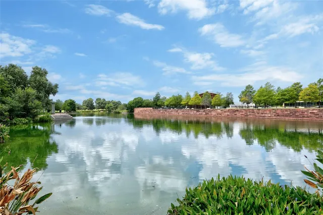 a view of a lake with houses in the back