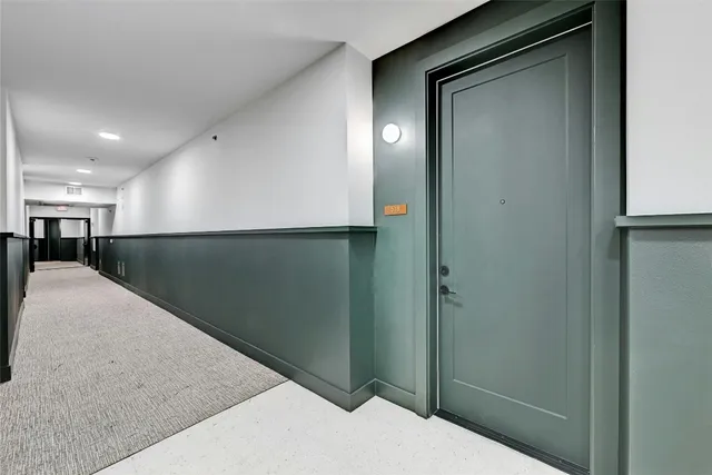 a view of an empty room with a kitchen