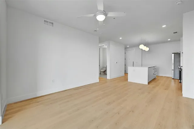 a view of a kitchen with a refrigerator and a window