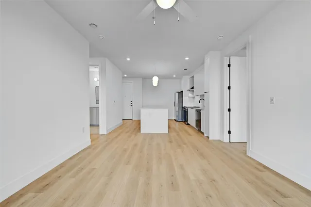 a view of a kitchen with a sink and a refrigerator