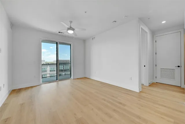 a large kitchen with stainless steel appliances a large counter top a stove and a refrigerator