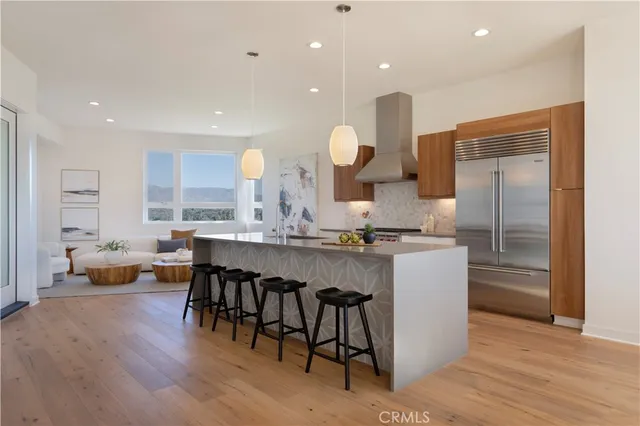 a large kitchen with a table and chairs