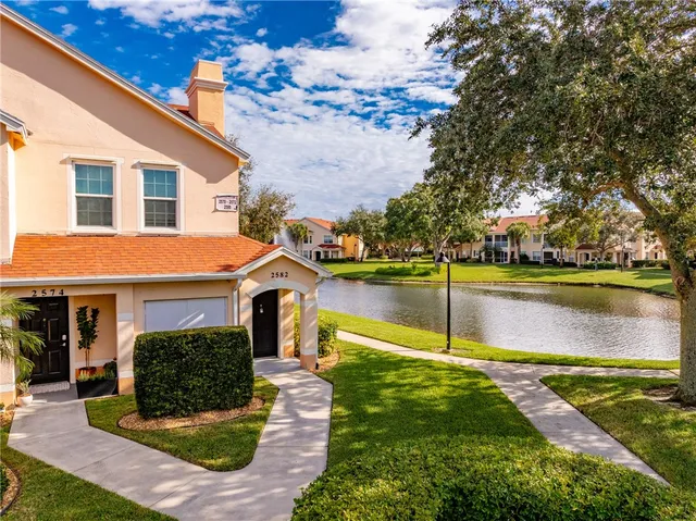 a view of a house with swimming pool and sitting area
