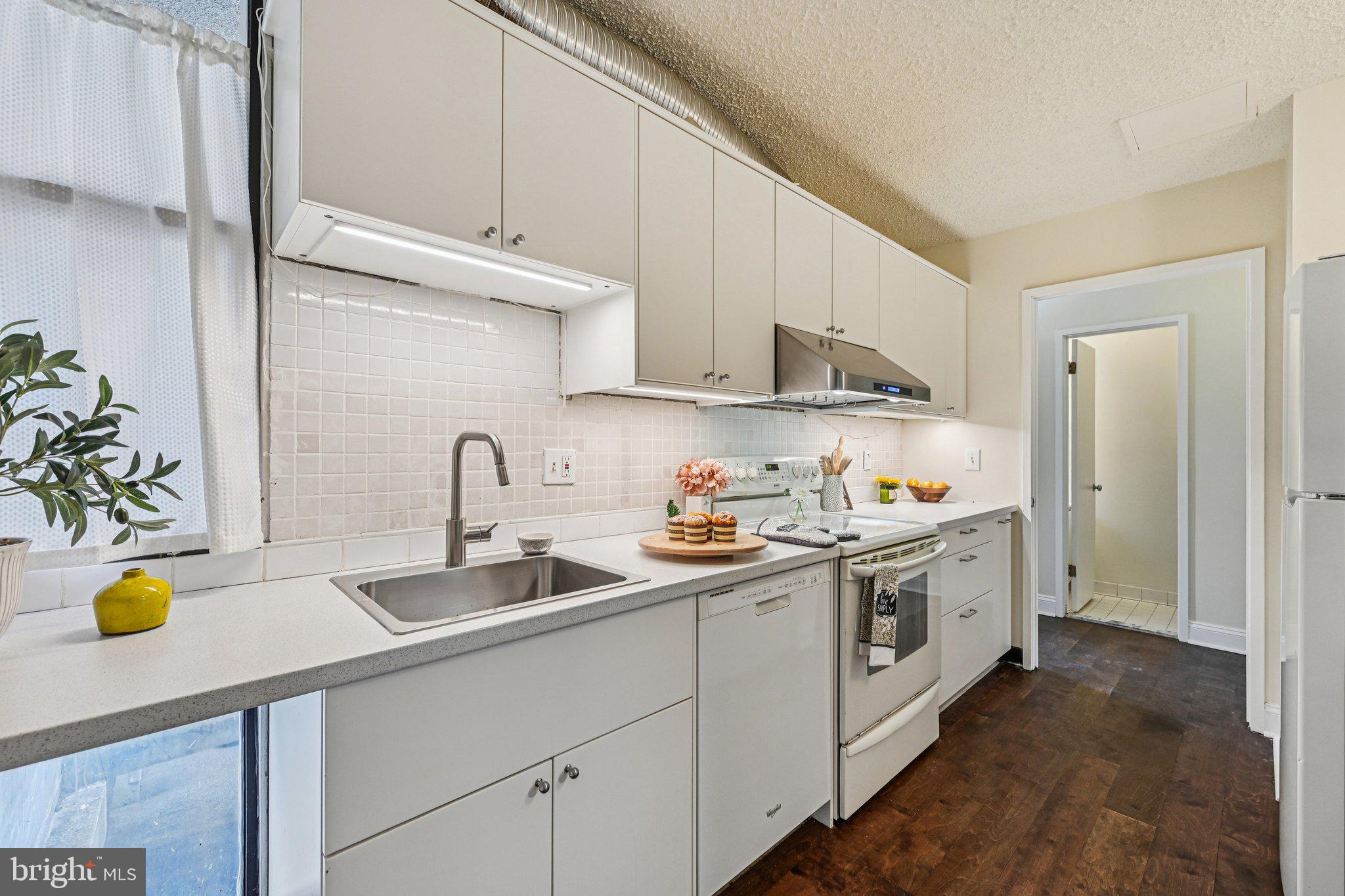 2303 Bayleaf Court Baltimore, MD 21209 - Photo 13 of 37 a kitchen with stainless steel appliances granite countertop a sink a stove and a refrigerator