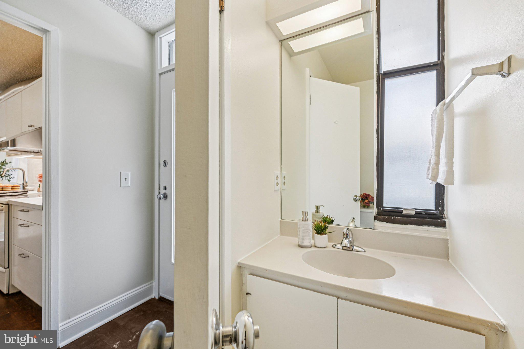 2303 Bayleaf Court Baltimore, MD 21209 - Photo 17 of 37 a bathroom with a sink and a mirror