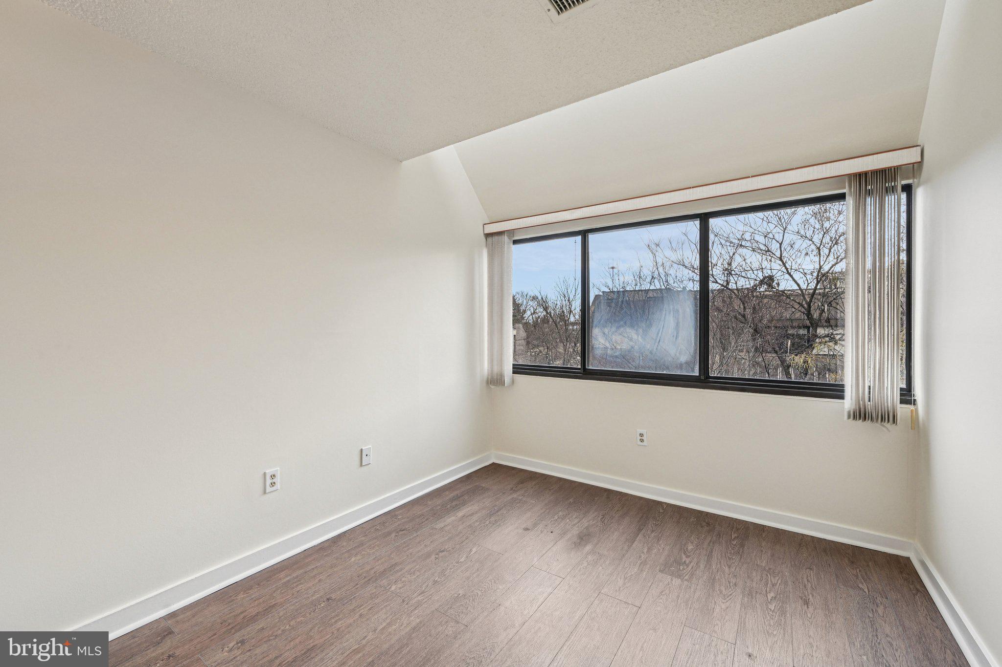 2303 Bayleaf Court Baltimore, MD 21209 - Photo 19 of 37 a view of an empty room with wooden floor and a window