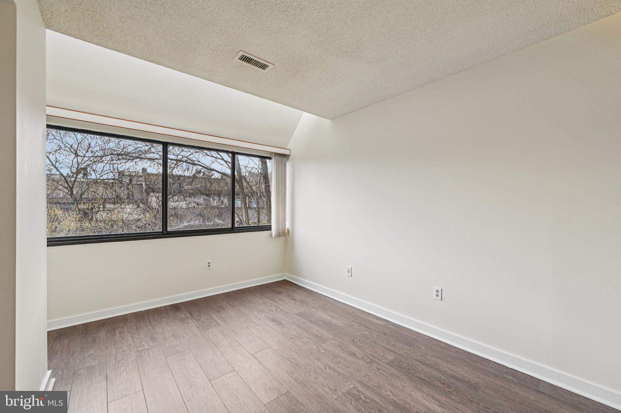 2303 Bayleaf Court Baltimore, MD 21209 - Photo 22 of 37 wooden floor in an empty room with a window