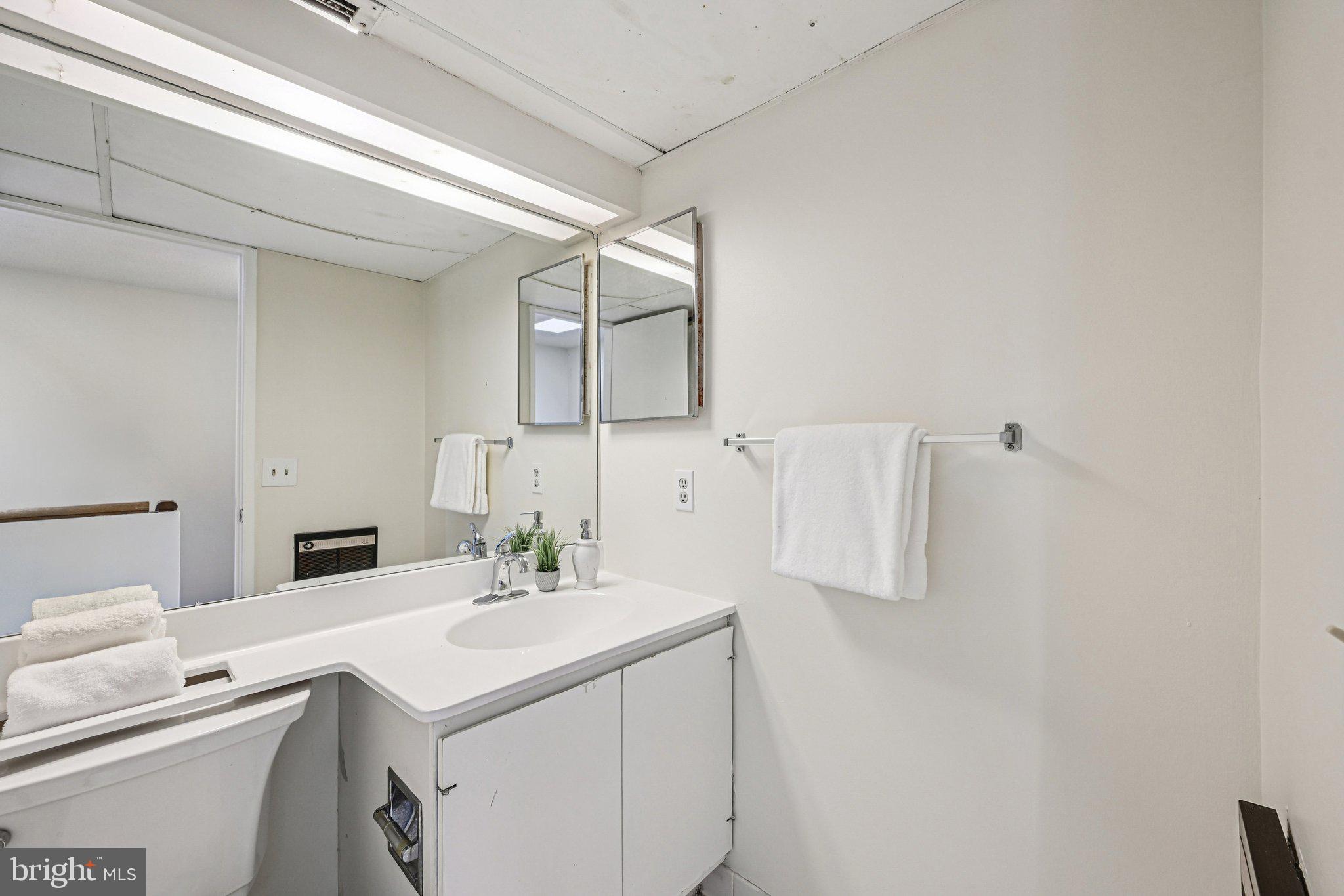 2303 Bayleaf Court Baltimore, MD 21209 - Photo 24 of 37 a bathroom with a sink vanity and a mirror