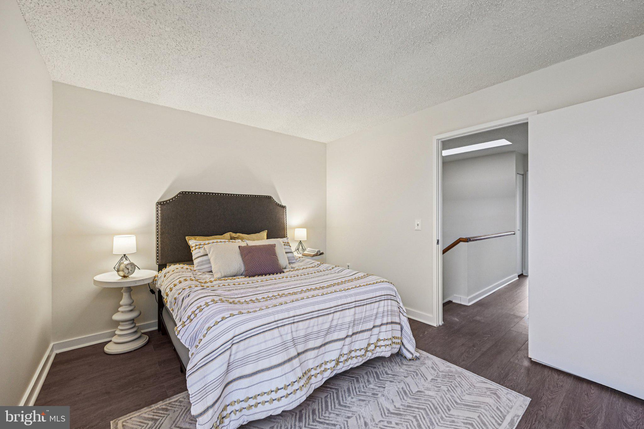 2303 Bayleaf Court Baltimore, MD 21209 - Photo 27 of 37 a bedroom with a bed and wooden floor
