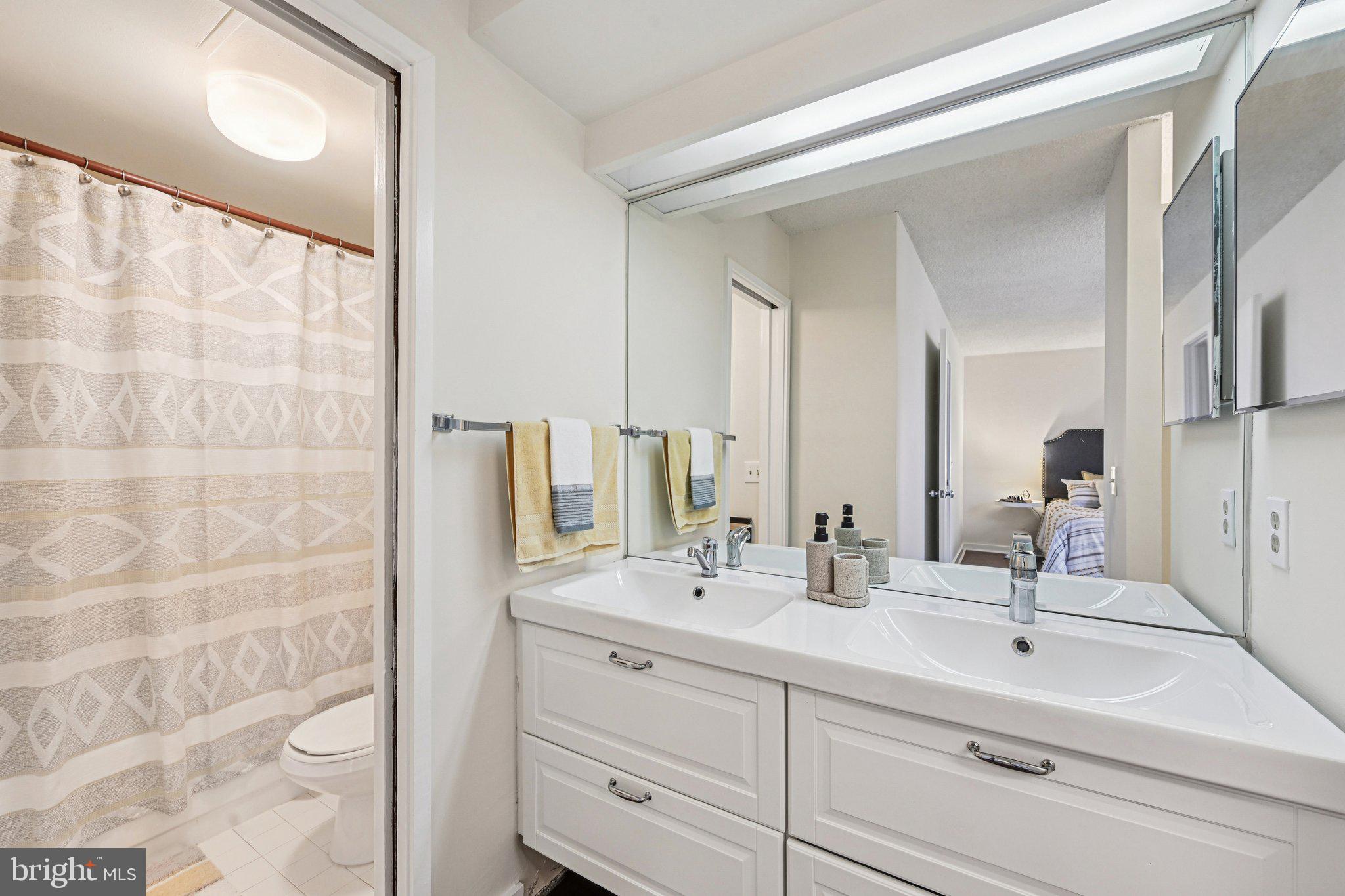 2303 Bayleaf Court Baltimore, MD 21209 - Photo 30 of 37 a bathroom with a double vanity sink mirror and