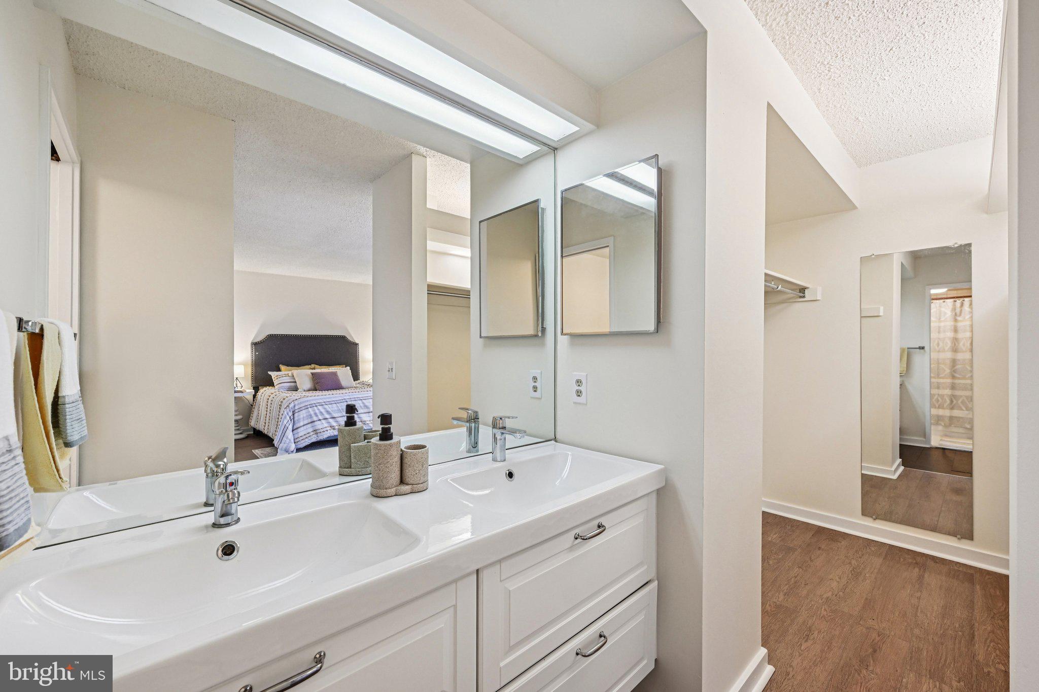 2303 Bayleaf Court Baltimore, MD 21209 - Photo 31 of 37 a bathroom with a sink and a mirror
