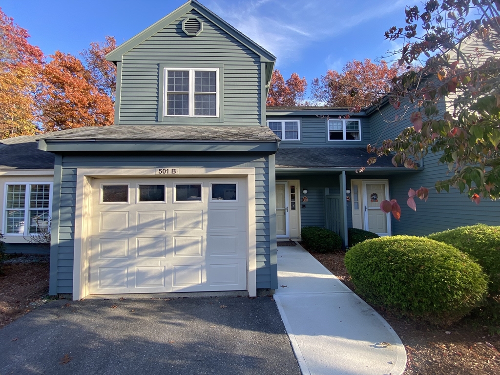 501 Ridgefield Circle, Unit B Clinton, MA 01510 - Photo 1 of 17 a front view of a house with a garden