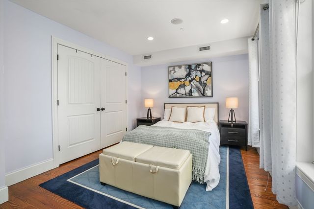 a bedroom with a bed and a painting on the wall