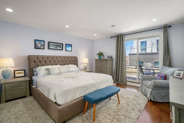 a spacious bedroom with a bed a couch and a couch