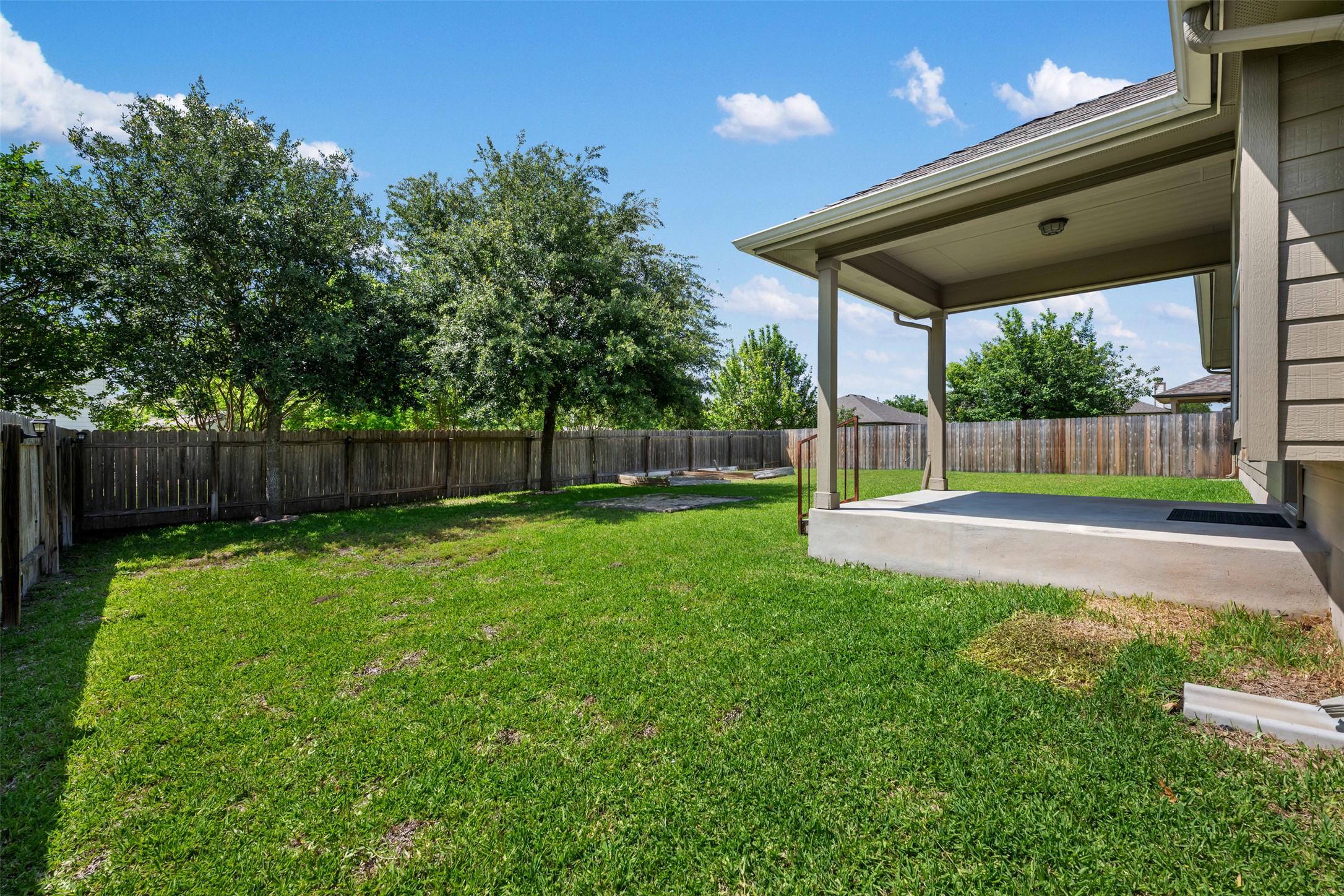18820 Edinburgh Castle Road Pflugerville, TX 78660 - Photo 36 of 37 a view of a wooden deck with a big yard