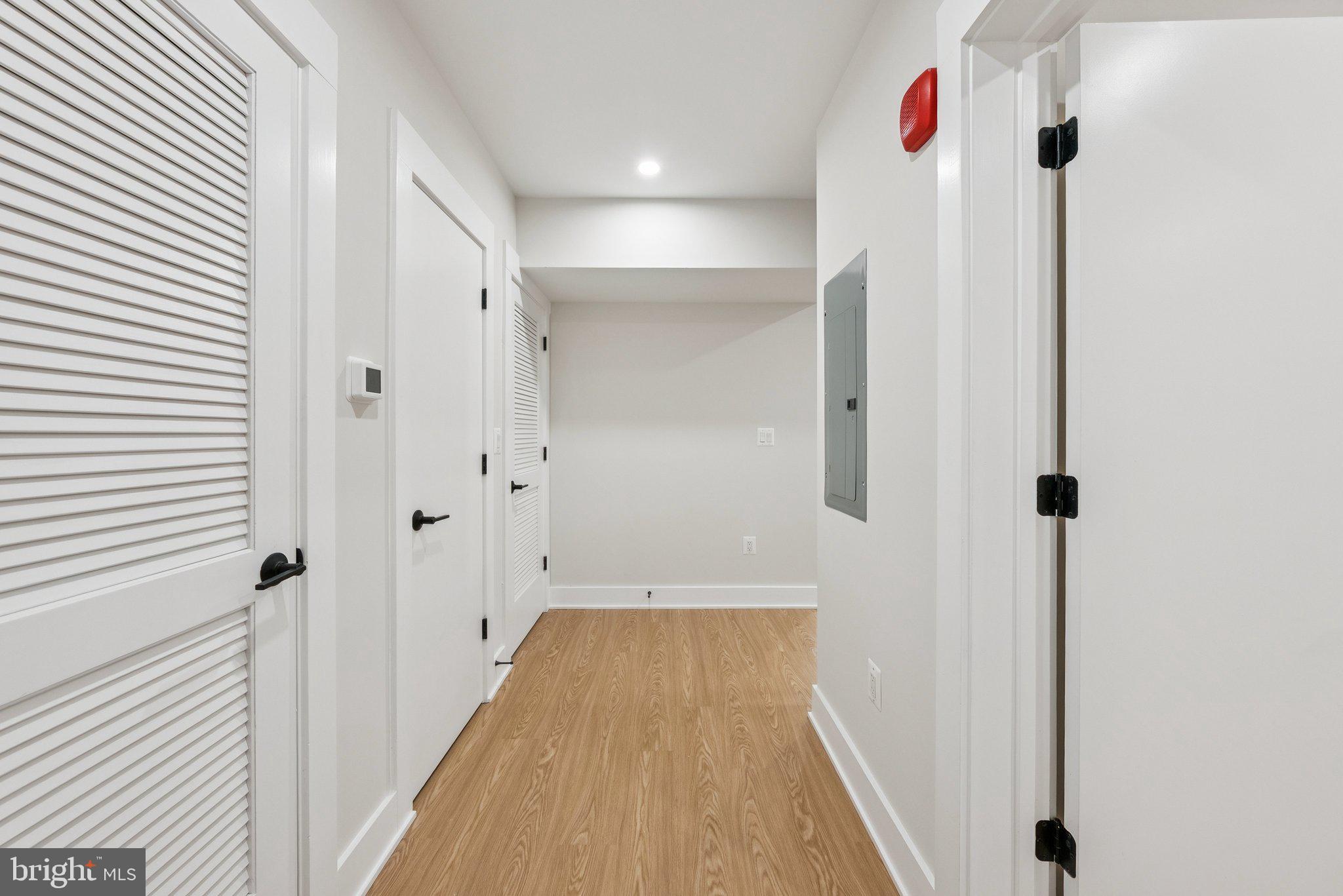 2134 Wisconsin Avenue Northwest, Unit 1 Washington, DC 20007 - Photo 3 of 32 a view of a hallway with wooden floor and staircase
