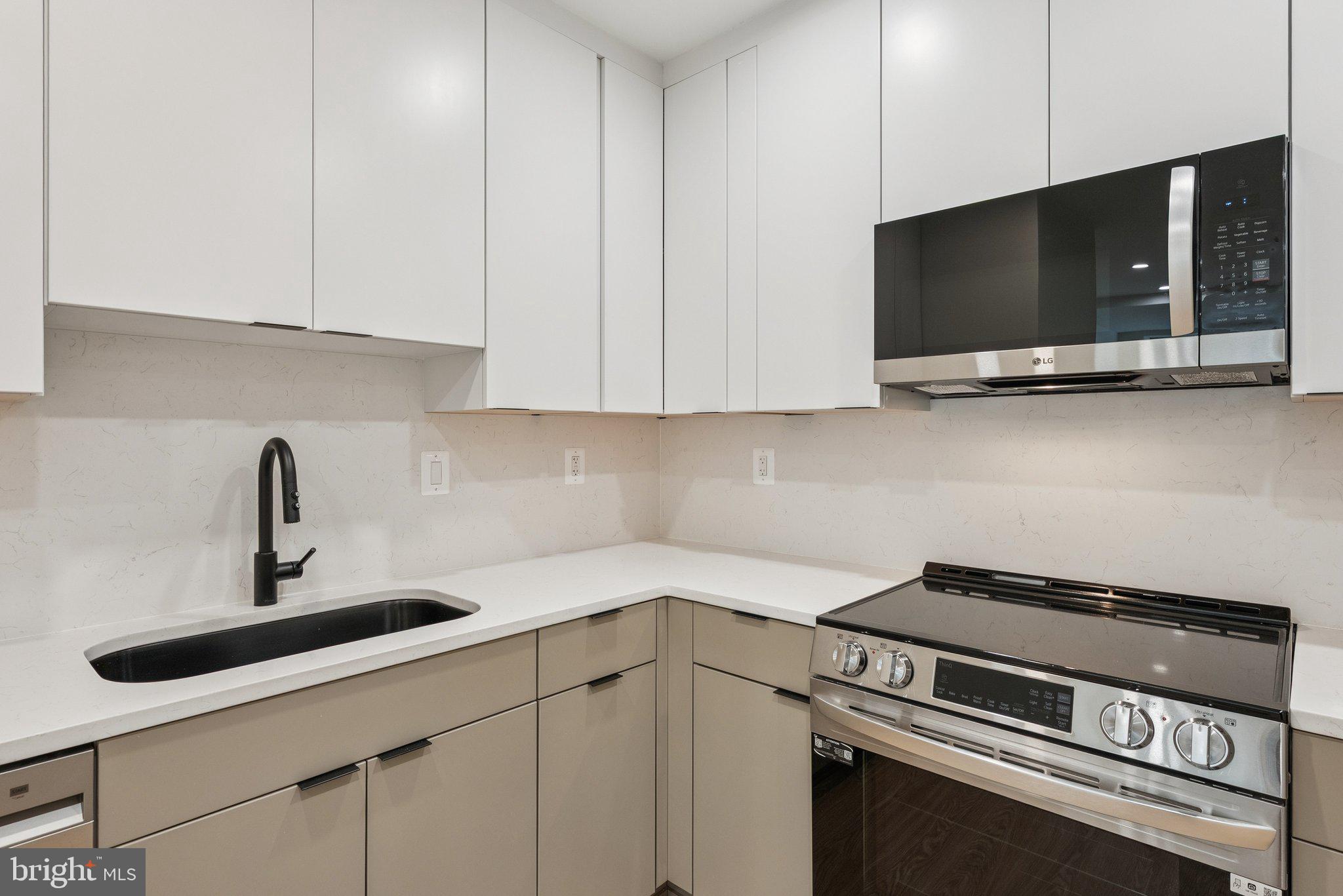 2134 Wisconsin Avenue Northwest, Unit 1 Washington, DC 20007 - Photo 6 of 32 a kitchen with a stove and a microwave