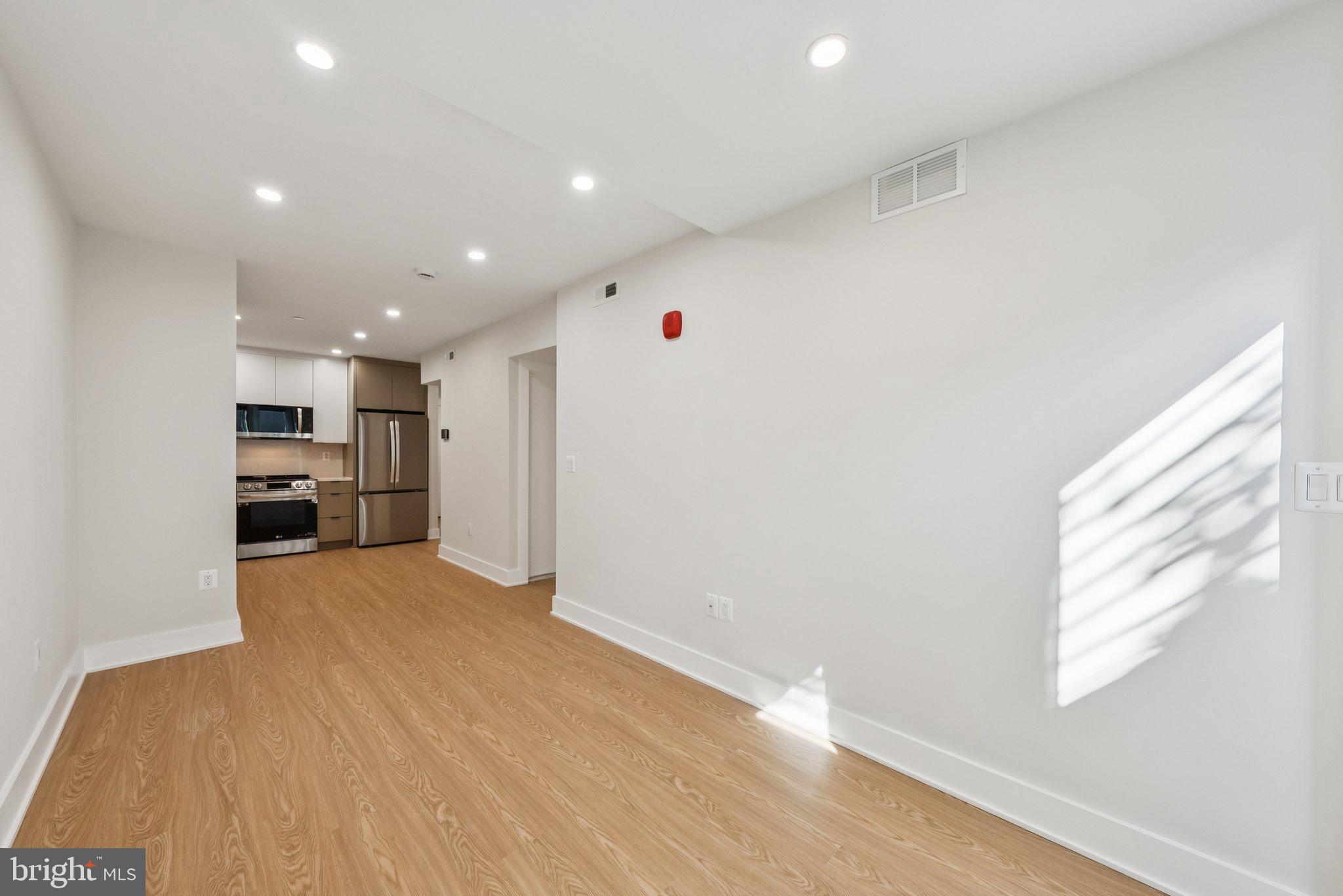2134 Wisconsin Avenue Northwest, Unit 1 Washington, DC 20007 - Photo 9 of 32 a view of a kitchen with wooden floor and windows