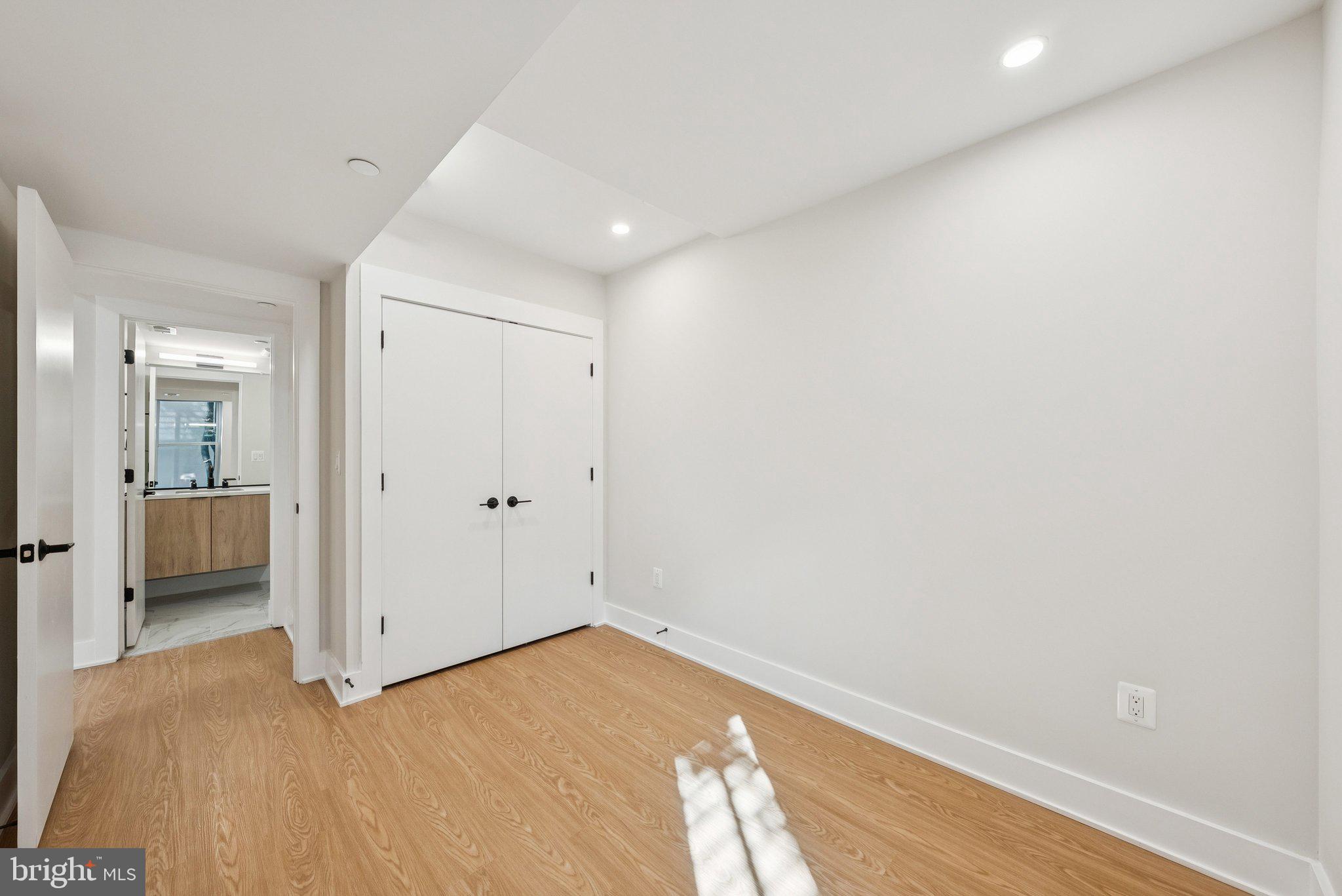 2134 Wisconsin Avenue Northwest, Unit 1 Washington, DC 20007 - Photo 10 of 32 a view of a big room with wooden floor and a bathroom