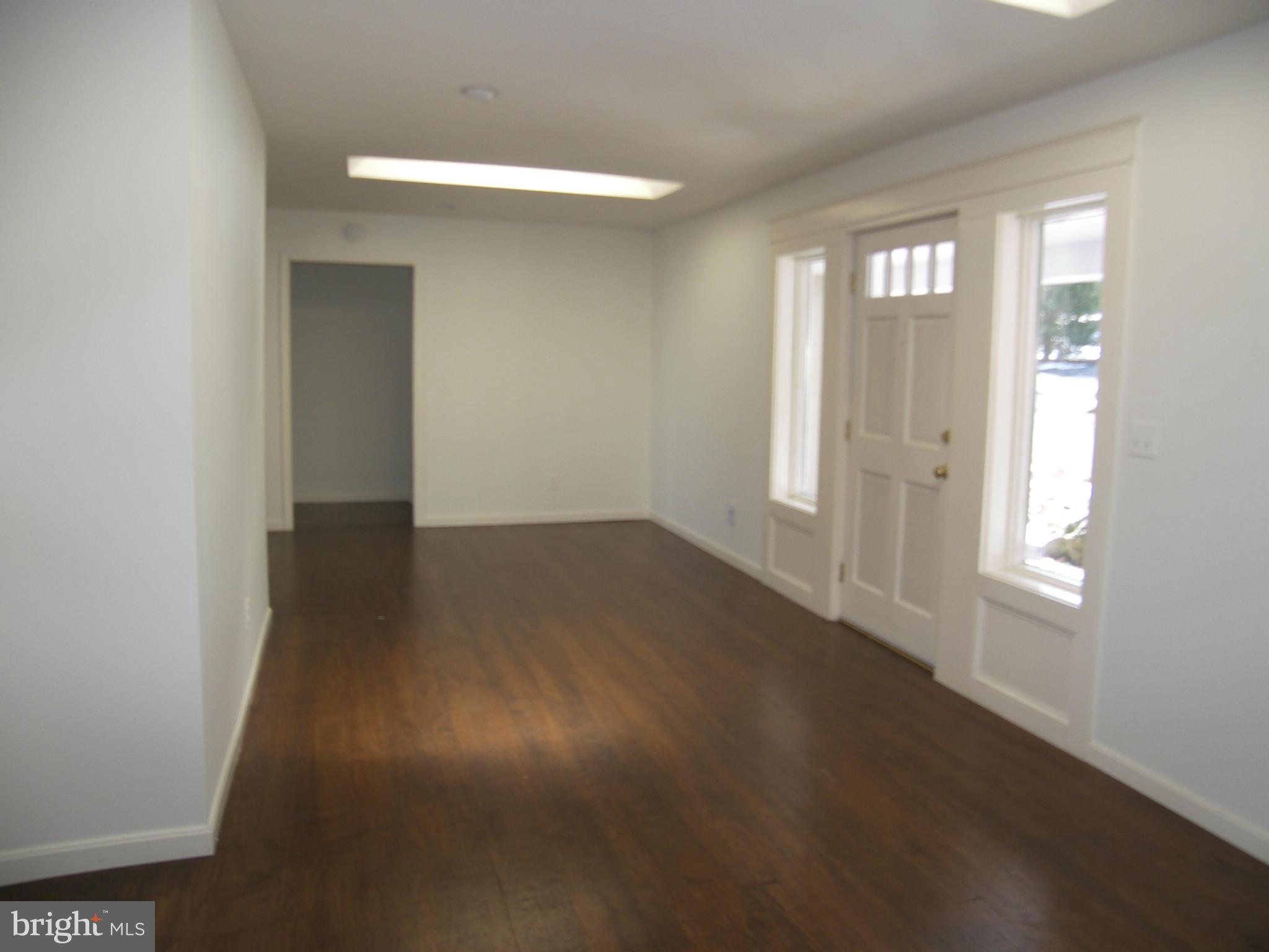 18458 Blue Ridge Mountain Road Bluemont, VA 20135 - Photo 2 of 30 an empty room with wooden floor and windows