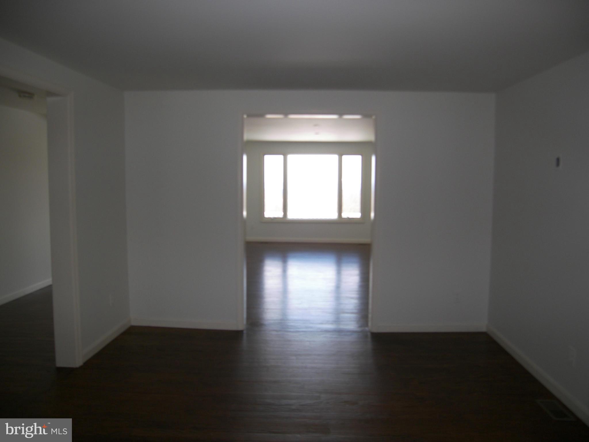 18458 Blue Ridge Mountain Road Bluemont, VA 20135 - Photo 13 of 30 an empty room with wooden floor and windows