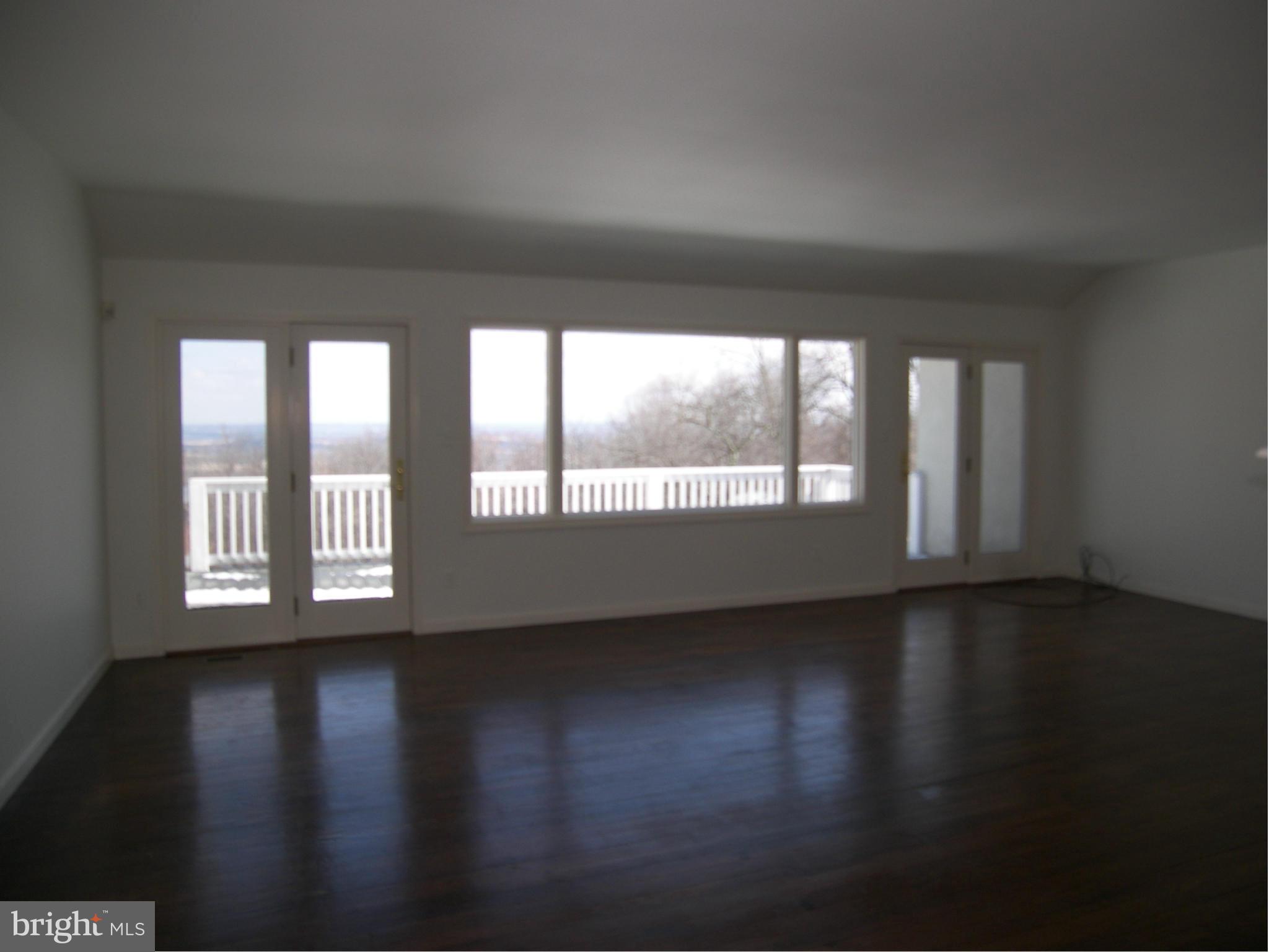 18458 Blue Ridge Mountain Road Bluemont, VA 20135 - Photo 3 of 30 a view of an empty room with wooden floor and a window
