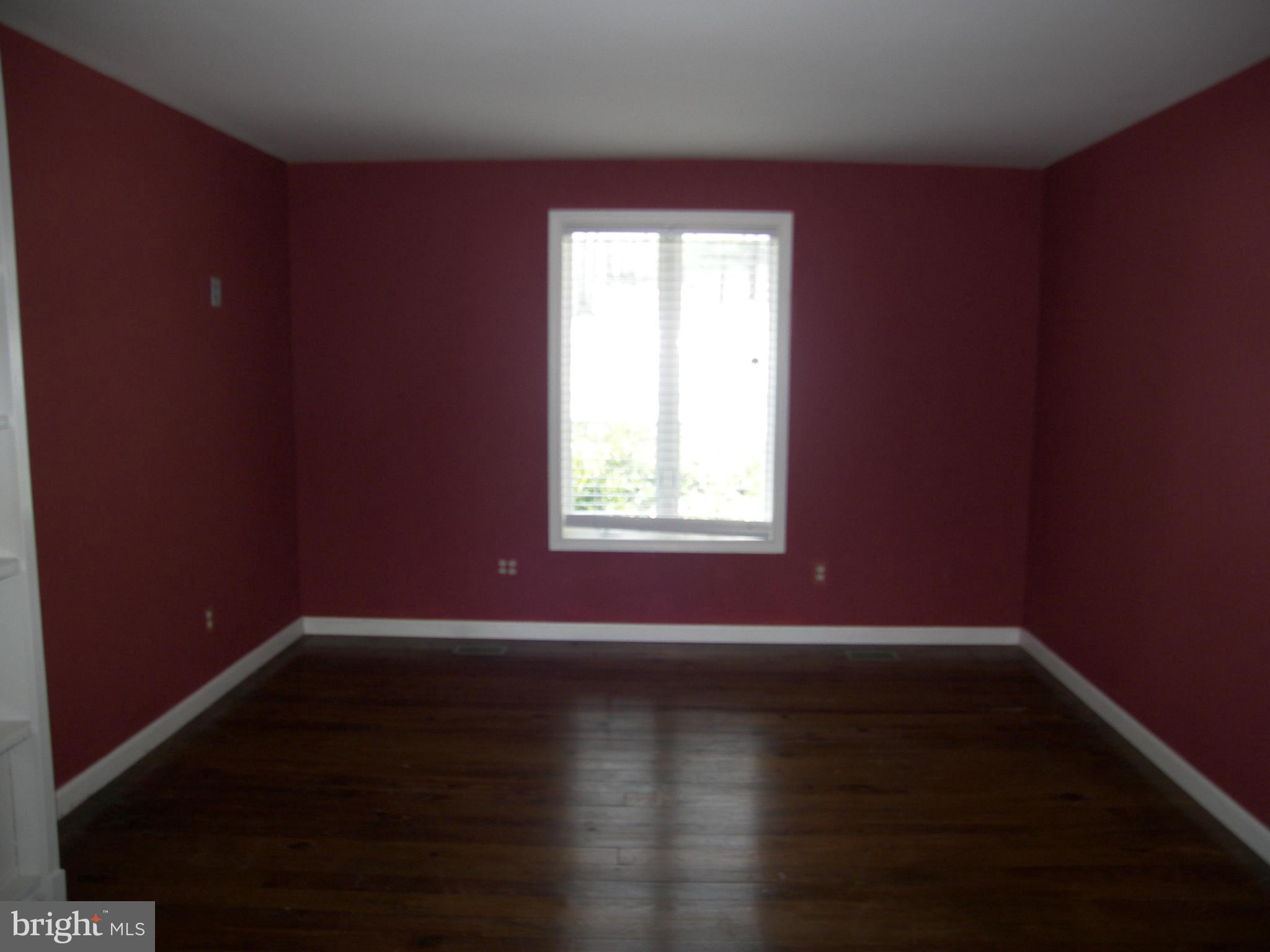 18458 Blue Ridge Mountain Road Bluemont, VA 20135 - Photo 9 of 30 an empty room with wooden floor and windows