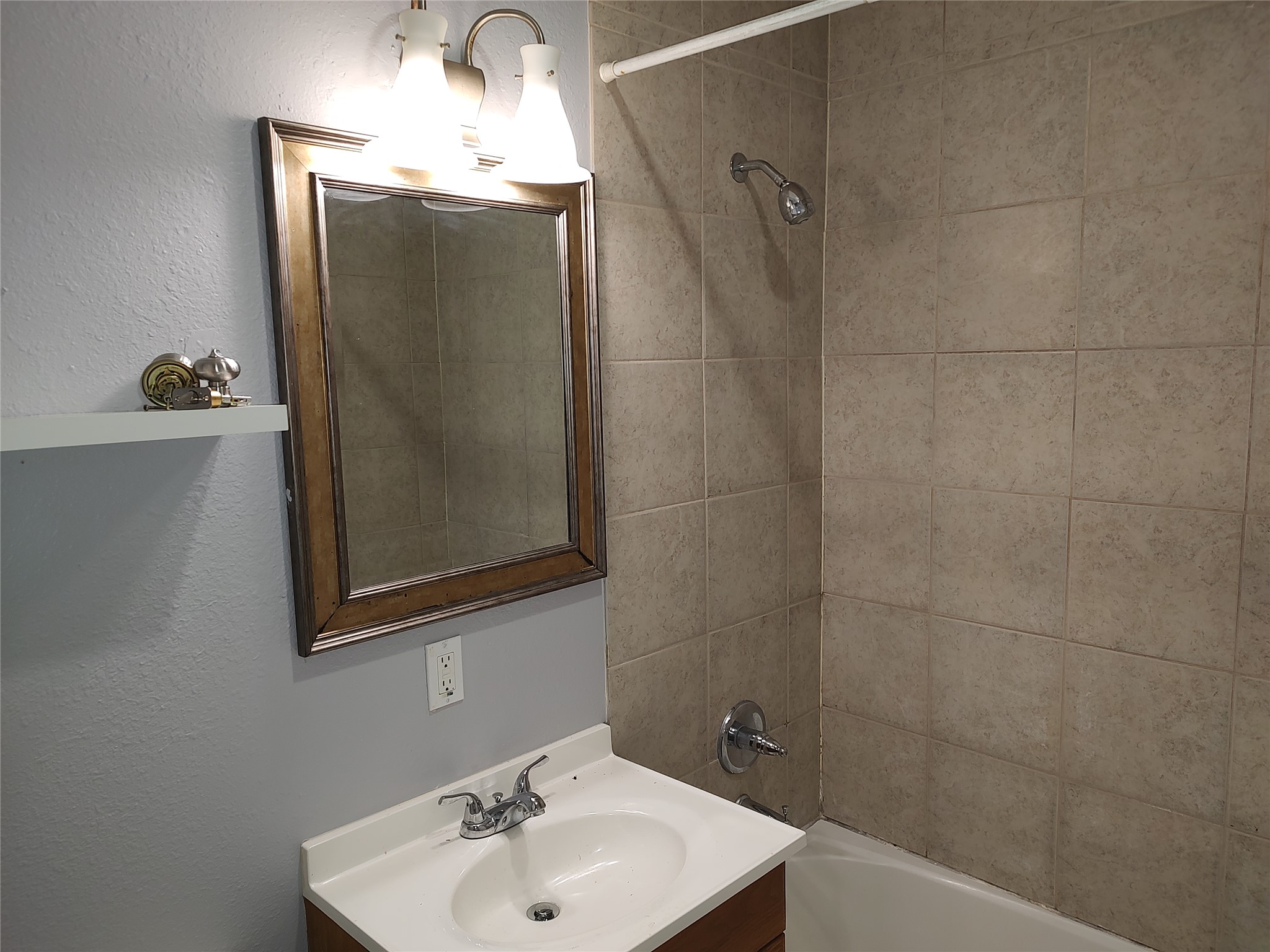 2617 Wheless Lane Austin, TX 78723 - Photo 12 of 14 Full bath featuring vanity, washtub / shower combination, and a textured wall
