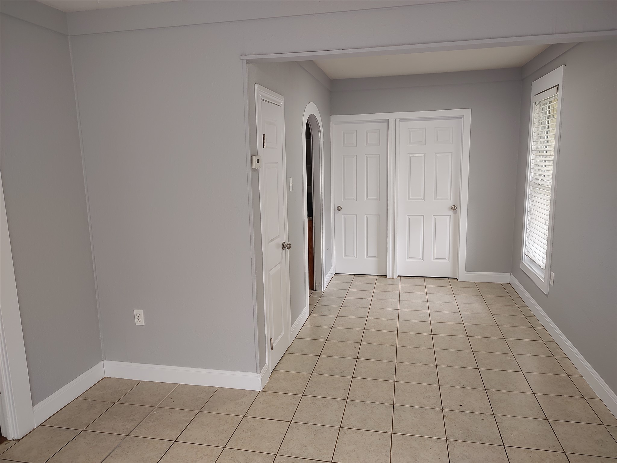 2617 Wheless Lane Austin, TX 78723 - Photo 3 of 14 Hallway featuring arched walkways and light tile patterned floors