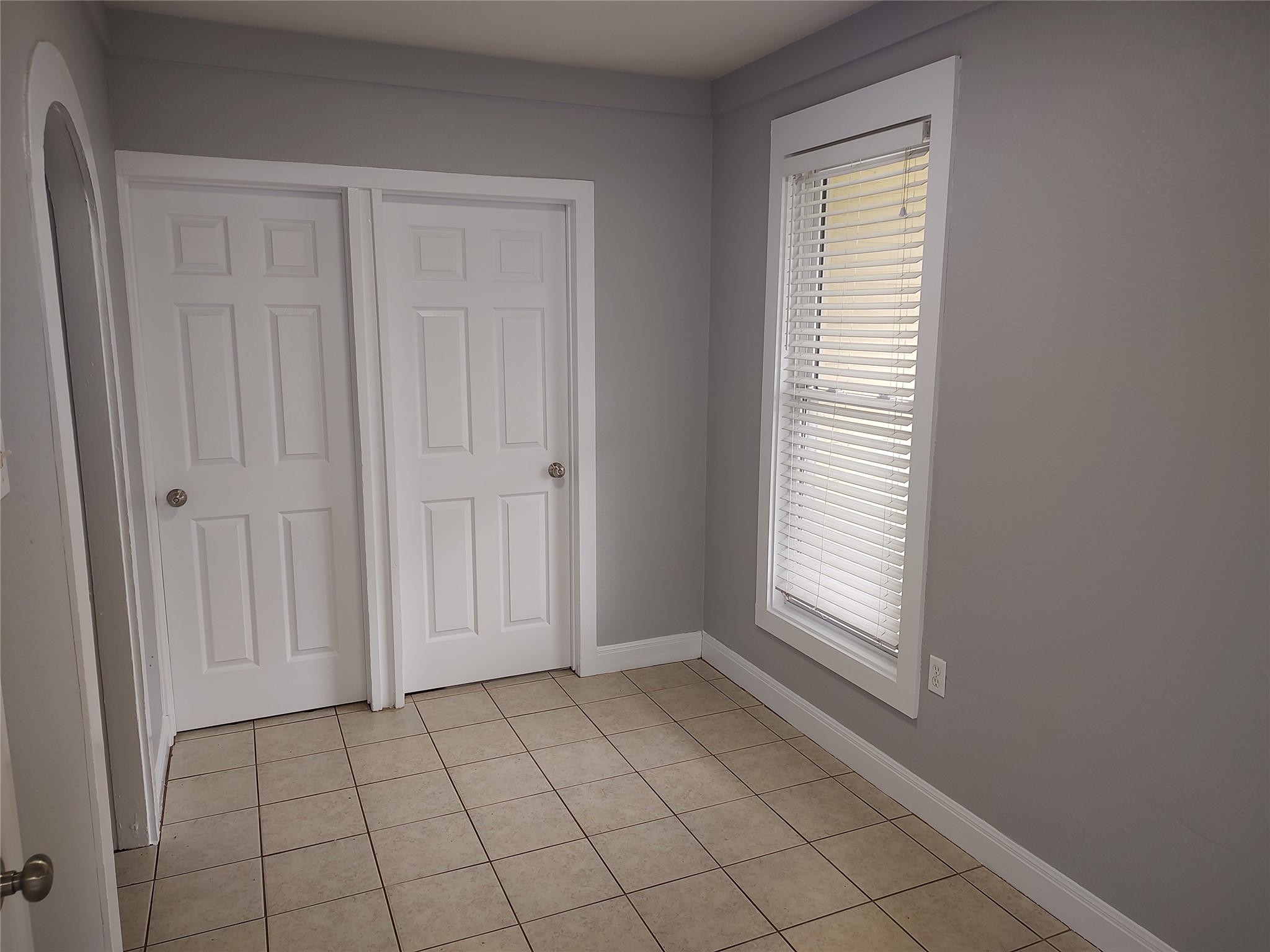 2617 Wheless Lane Austin, TX 78723 - Photo 4 of 14 Unfurnished bedroom featuring light tile patterned floors and a closet