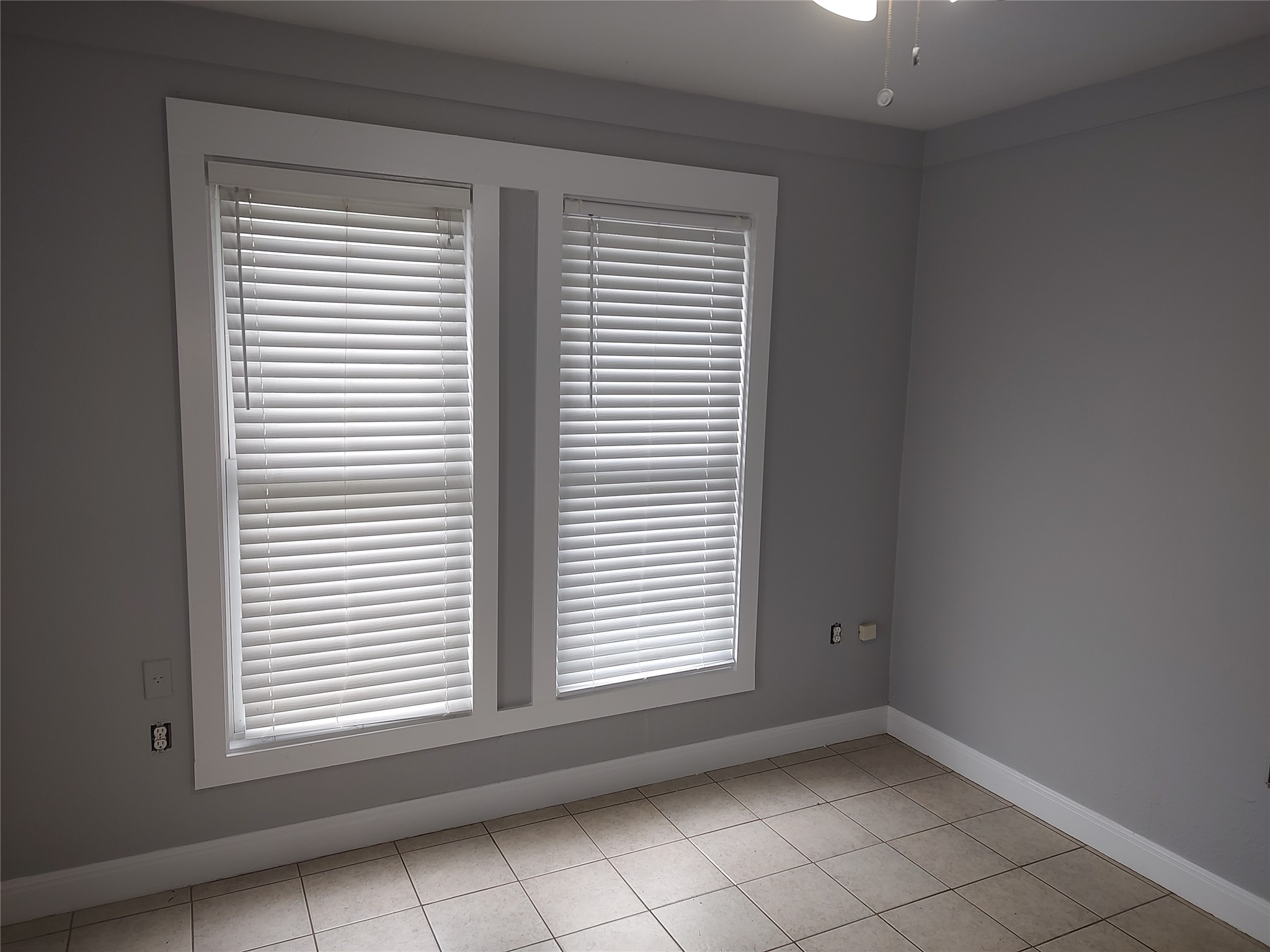 2617 Wheless Lane Austin, TX 78723 - Photo 5 of 14 Empty room with light tile patterned floors and ceiling fan