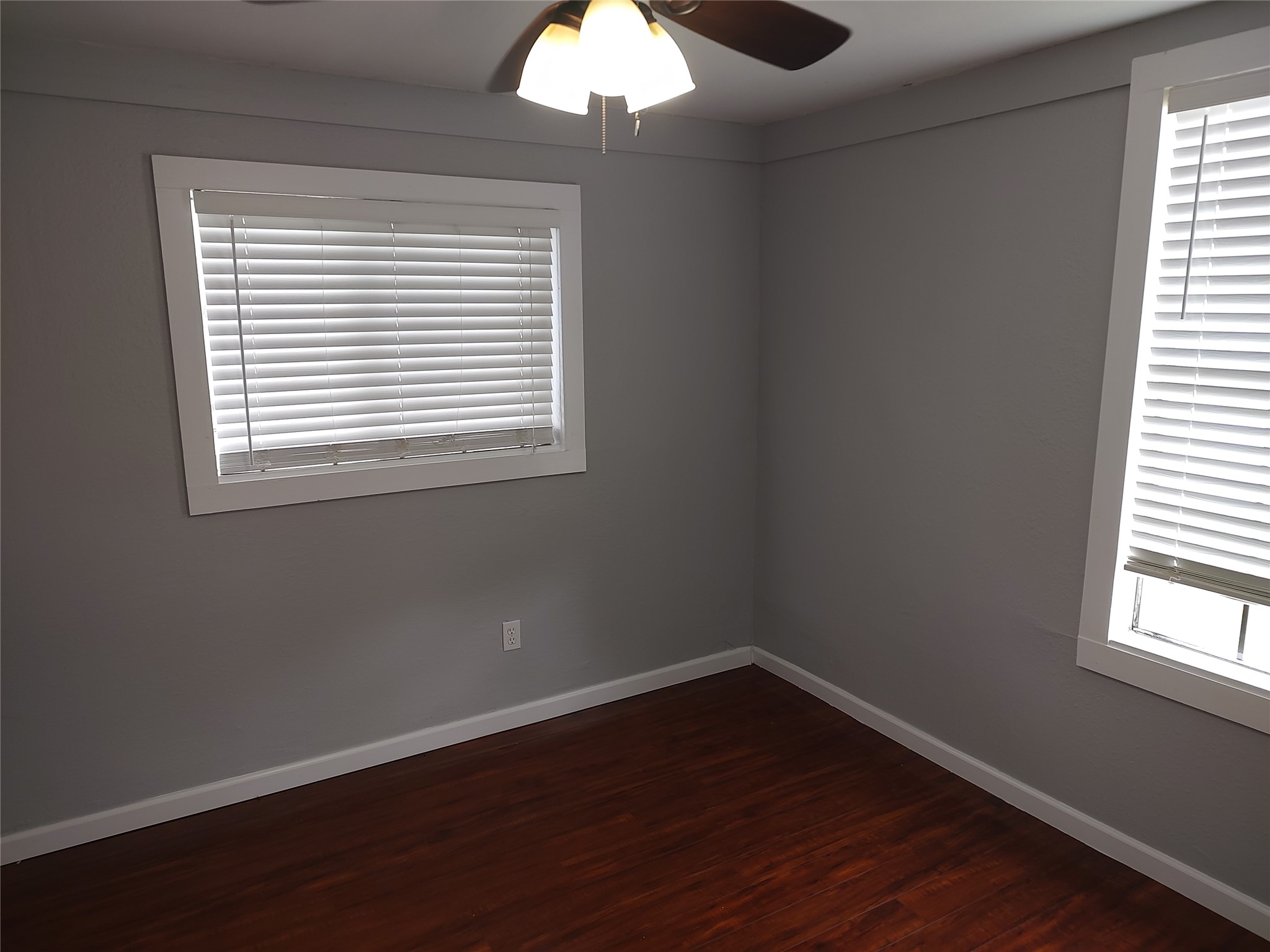 2617 Wheless Lane Austin, TX 78723 - Photo 9 of 14 Unfurnished room with ceiling fan and dark wood finished floors