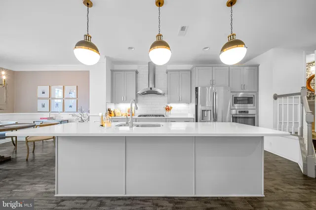 a living room with a couch and a dining table with wooden floor