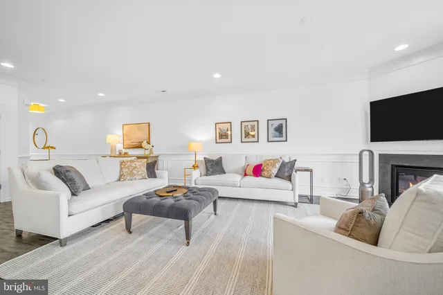 a view of a bedroom with wooden floor and windows