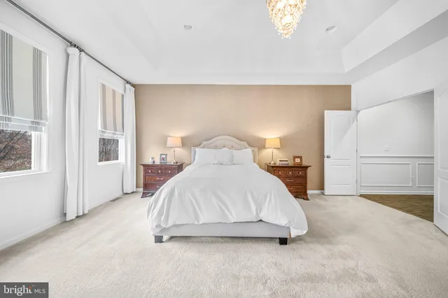 a spacious bathroom with a granite countertop sink mirror and
