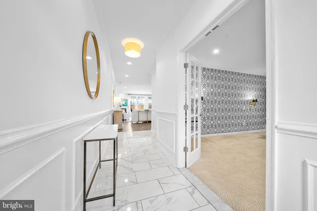 a kitchen with stainless steel appliances a refrigerator a stove a sink dishwasher a oven with white cabinets and wooden floor