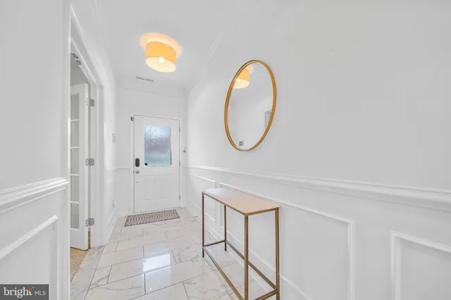a kitchen with white cabinets appliances and a sink