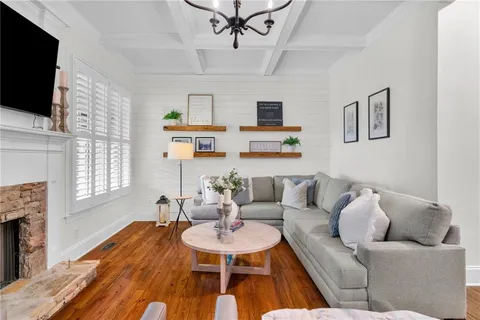 a dining room with furniture potted plants and wooden floor