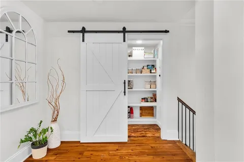 a bathroom with a granite countertop shower a sink and a mirror