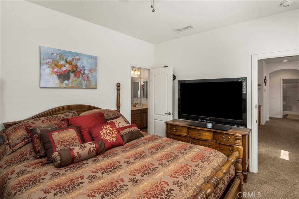 12652 Twin Peak Court Riverside, CA 92503 - Photo 31 of 55 a bedroom with a bed and a flat screen tv